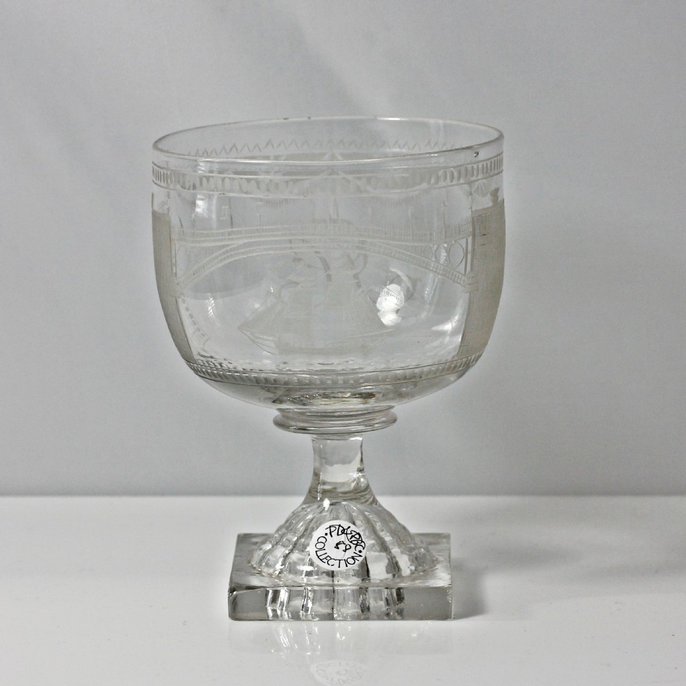 A clear Georgian glass rummer featuring a wheel-engraved Sunderland Bridge motif set above a square press-moulded base. View V
