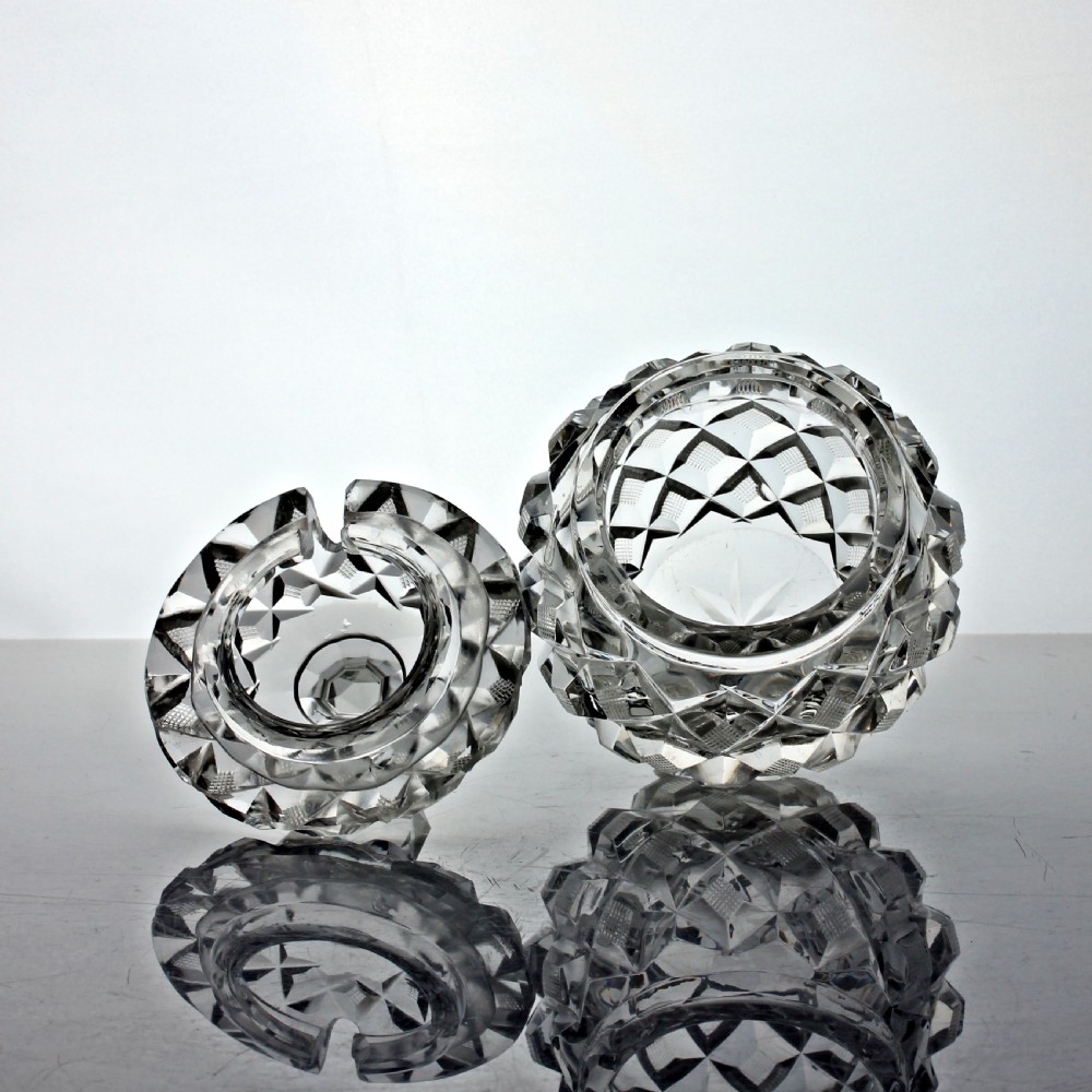 An Edwardian clear cut glass preserve pot featuring a strawberry diamond pattern and a fitted lid topped with a faceted finial. View II