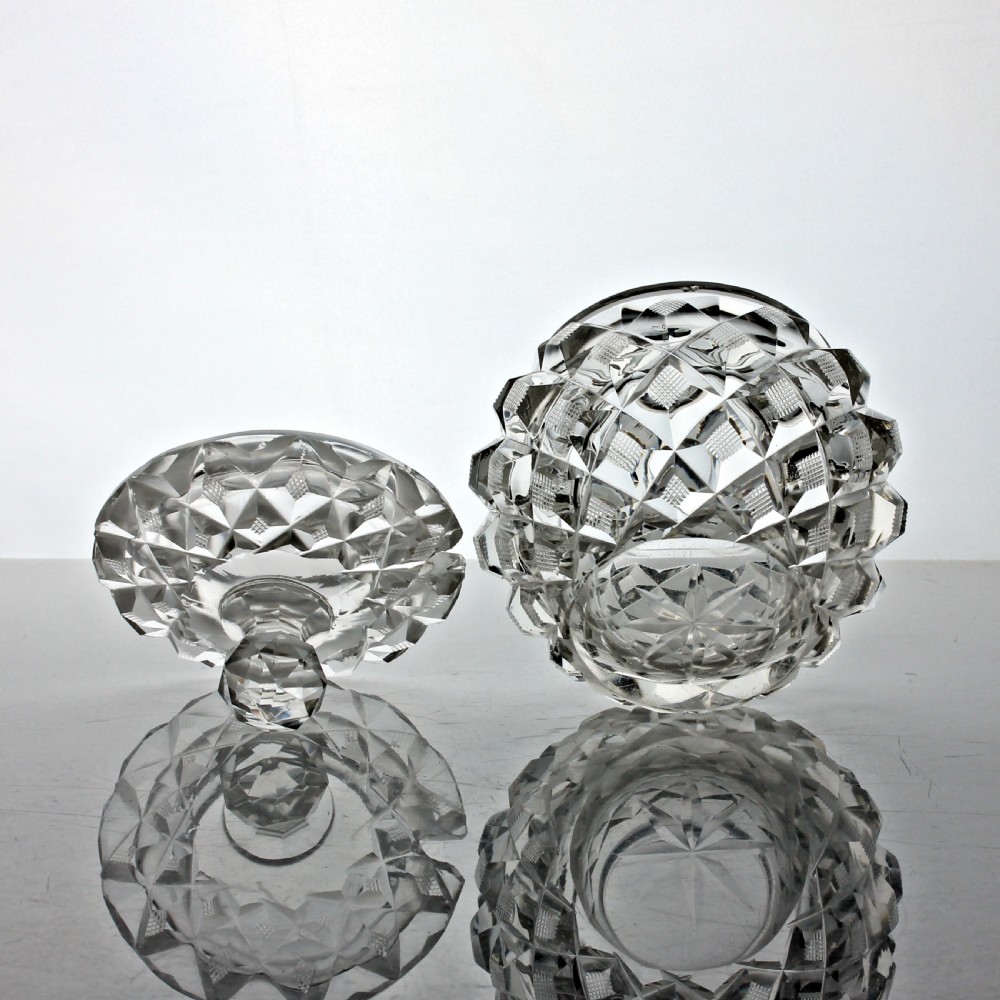 An Edwardian clear cut glass preserve pot featuring a strawberry diamond pattern and a fitted lid topped with a faceted finial. View III