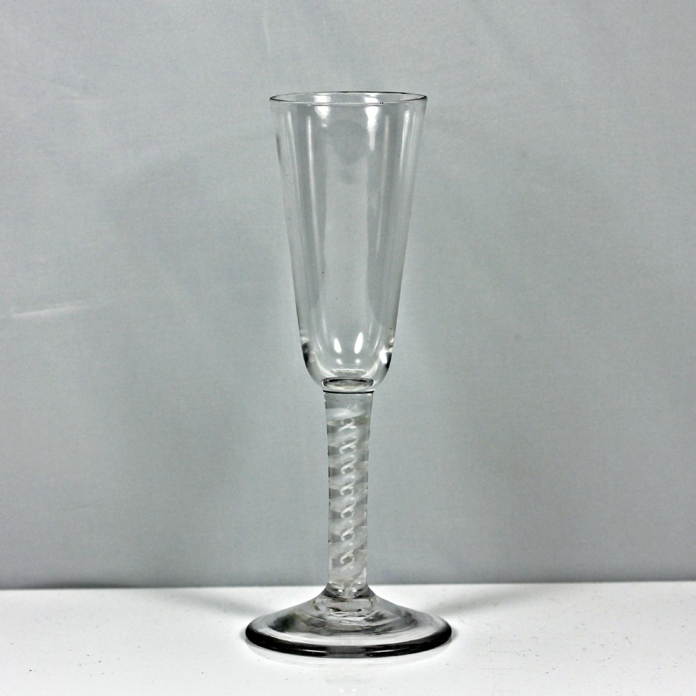 An eighteenth-century Georgian ale glass featuring a tall conical bowl, an opaque white double-twist stem, and a circular conical foot.