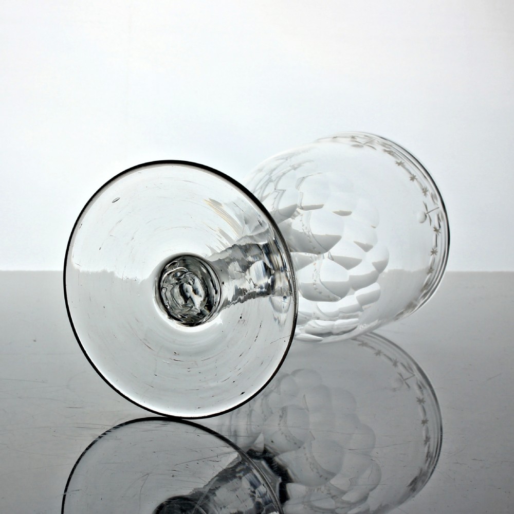 A clear Georgian lead glass wine goblet featuring an engraved rim border, a round funnel bowl, diamond facet-cut stem, and a flat conical foot. View III