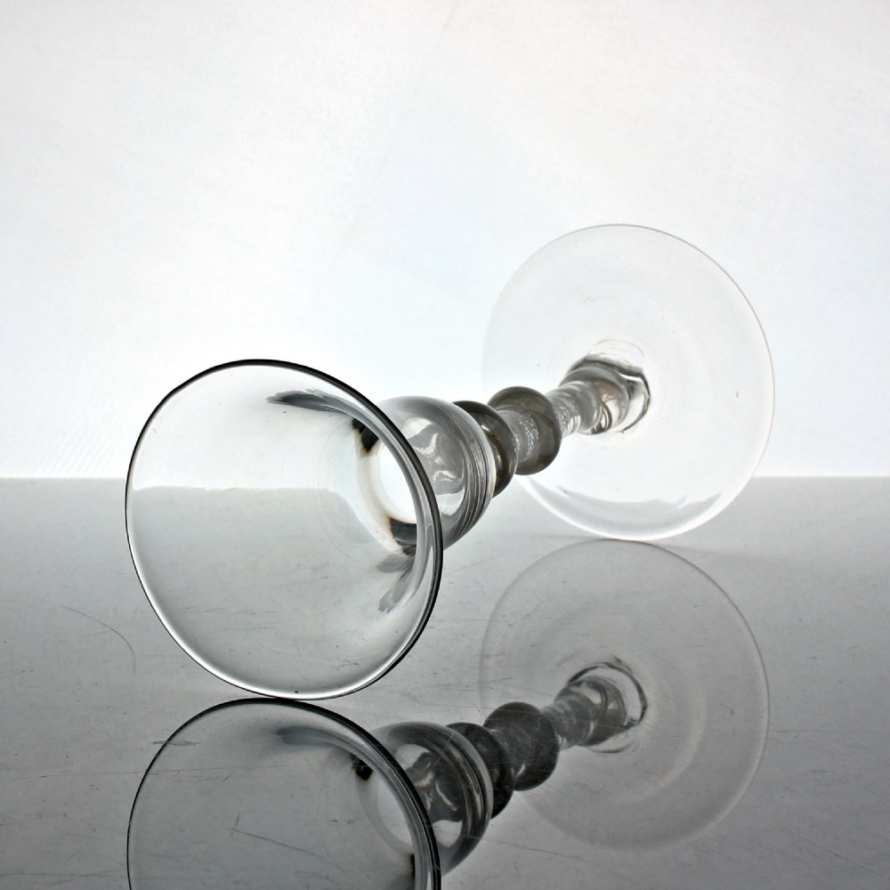 A Georgian clear glass wine goblet featuring a flared bell bowl and a triple-knopped stem with an internal white opaque twist pattern. View III