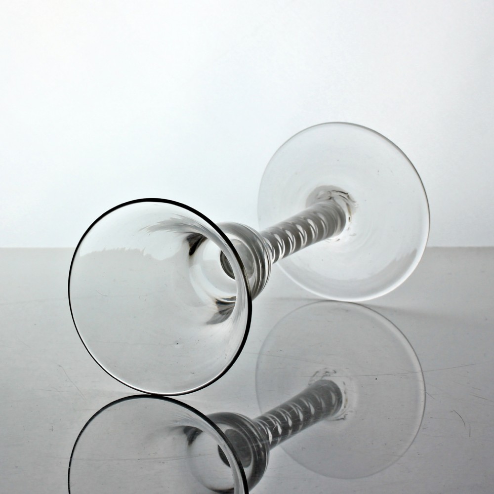 A Georgian clear glass wine glass featuring a flared bell bowl and an internal double series white opaque twist stem. View II