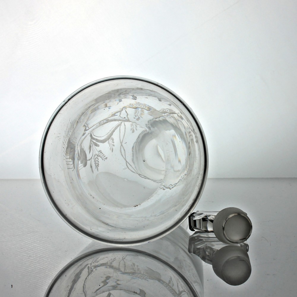 A clear Georgian sugarloaf glass decanter featuring wheel-engraved foliage, a cartouche inscribed with the word BEER, and a faceted stopper. View V