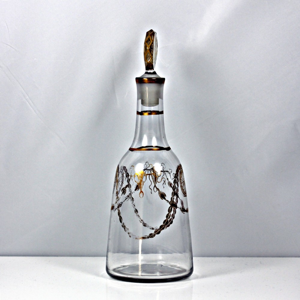 An eighteenth-century clear glass decanter featuring gilded festoon patterns, gold rim details, and a faceted wheel-engraved stopper with gilt rosettes. View III