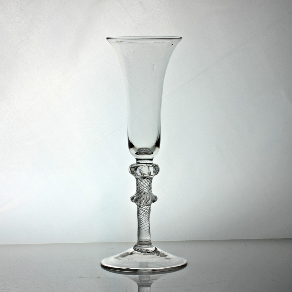 A clear Georgian air twist ale glass featuring a bell-shaped bowl, a double knopped stem with internal air spirals, and a conical foot. View II