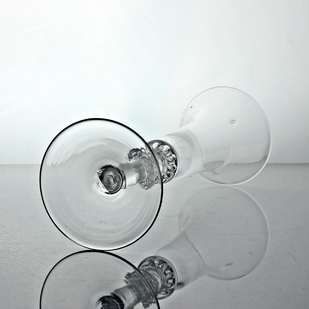 A clear Georgian air twist ale glass featuring a bell-shaped bowl, a double knopped stem with internal air spirals, and a conical foot. View III