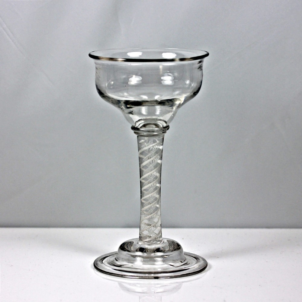A clear Georgian lead glass coupe featuring a double series opaque twist stem set on a circular foot.