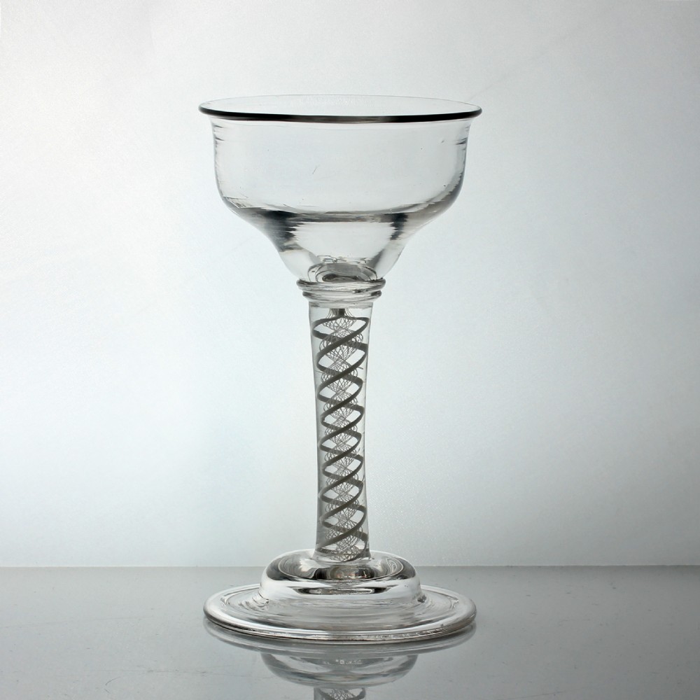 A clear Georgian lead glass coupe featuring a double series opaque twist stem set on a circular foot. View II