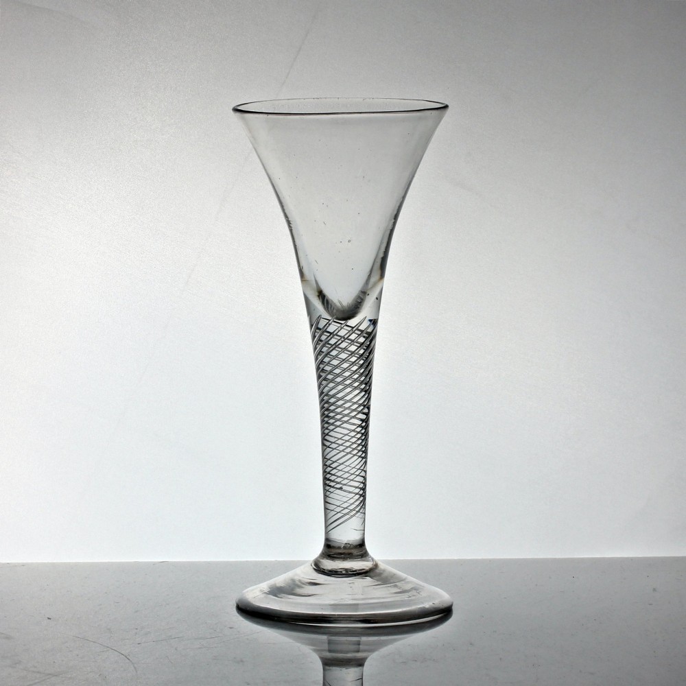 An 18th-century Georgian clear glass wine goblet featuring a flared trumpet bowl, an internal multi-spiral air twist stem, and a circular foot.