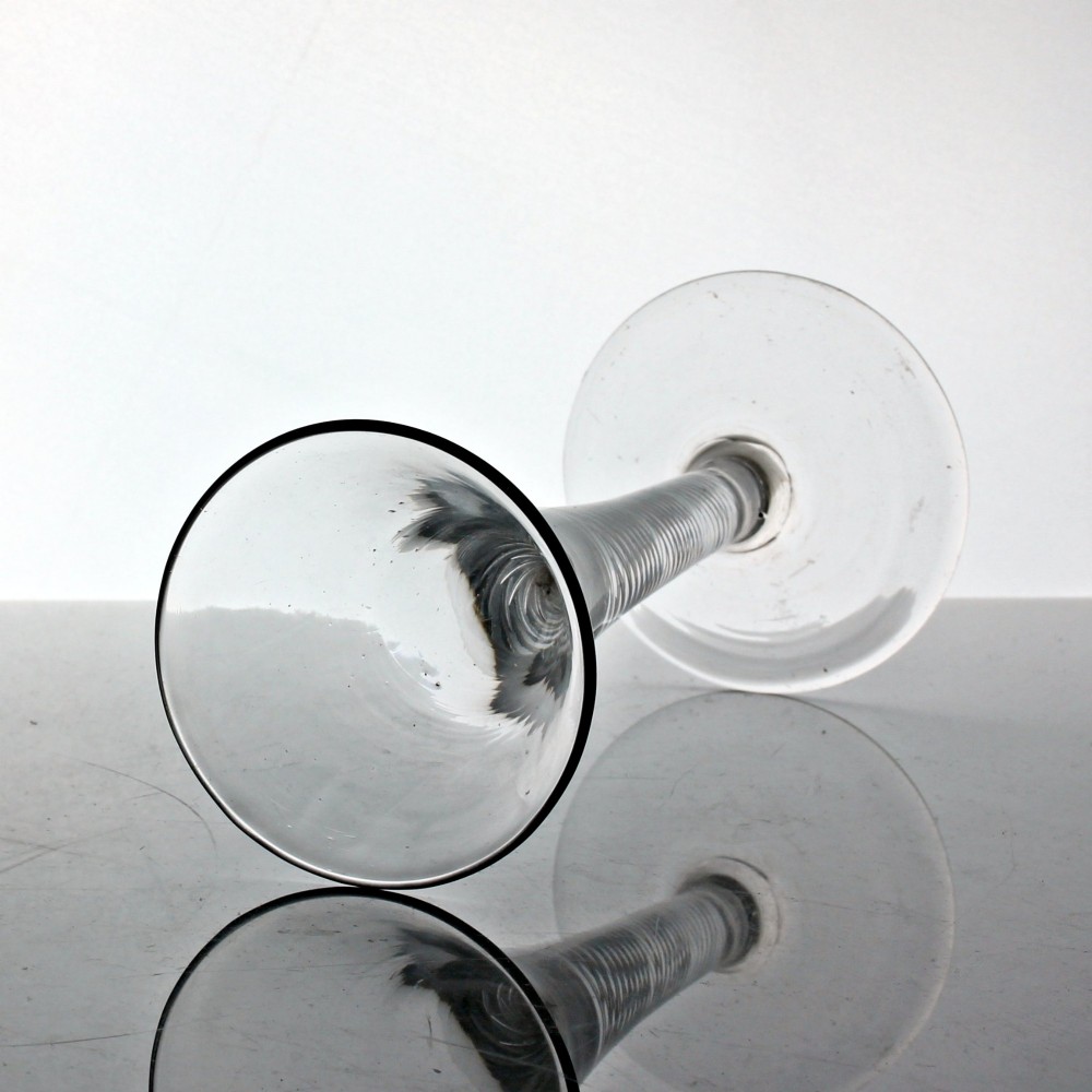 An 18th-century Georgian clear glass wine goblet featuring a flared trumpet bowl, an internal multi-spiral air twist stem, and a circular foot. View II