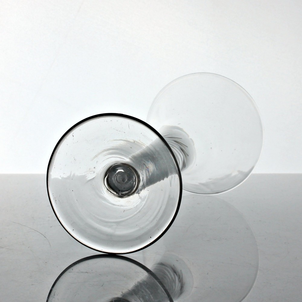 An 18th-century Georgian clear glass wine goblet featuring a flared trumpet bowl, an internal multi-spiral air twist stem, and a circular foot. View III