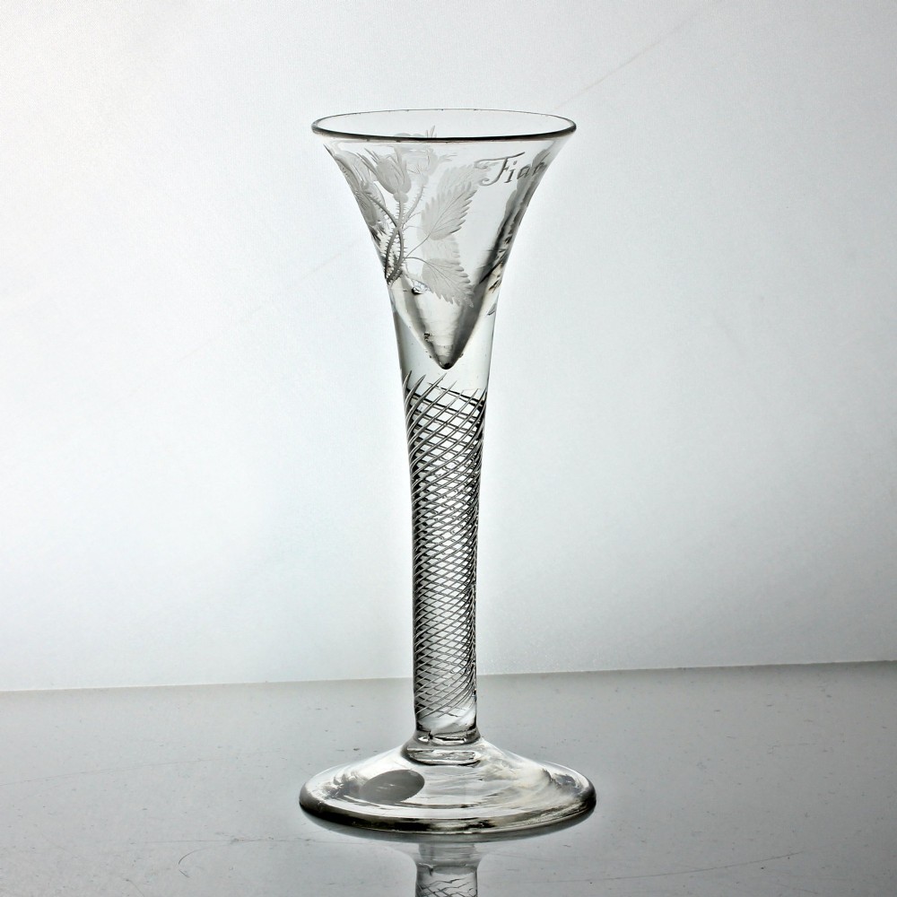 A clear Georgian air twist wine glass featuring a trumpet-shaped bowl with wheel-engraved rose motifs and a multi-spiral twist stem. View II