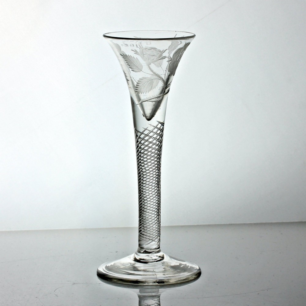 A clear Georgian air twist wine glass featuring a trumpet-shaped bowl with wheel-engraved rose motifs and a multi-spiral twist stem. View V