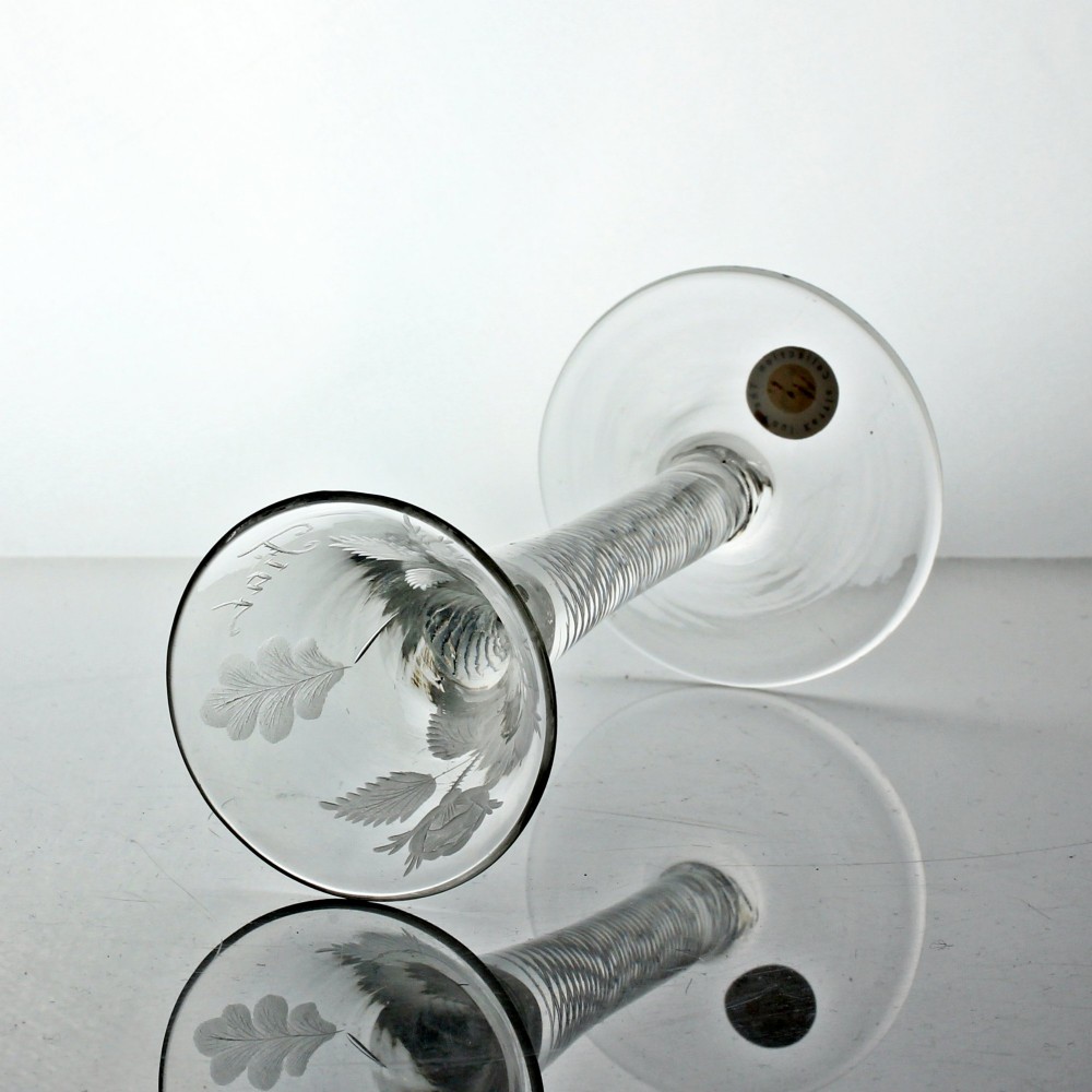 A clear Georgian air twist wine glass featuring a trumpet-shaped bowl with wheel-engraved rose motifs and a multi-spiral twist stem. View VI