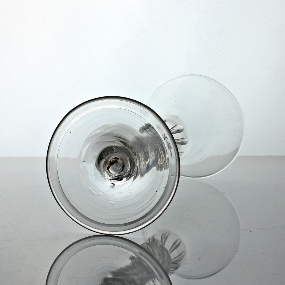 A clear Georgian lead glass wine goblet with a flared bell bowl, a multi-spiral air twist stem featuring a shoulder knop, and a conical folded foot. View III