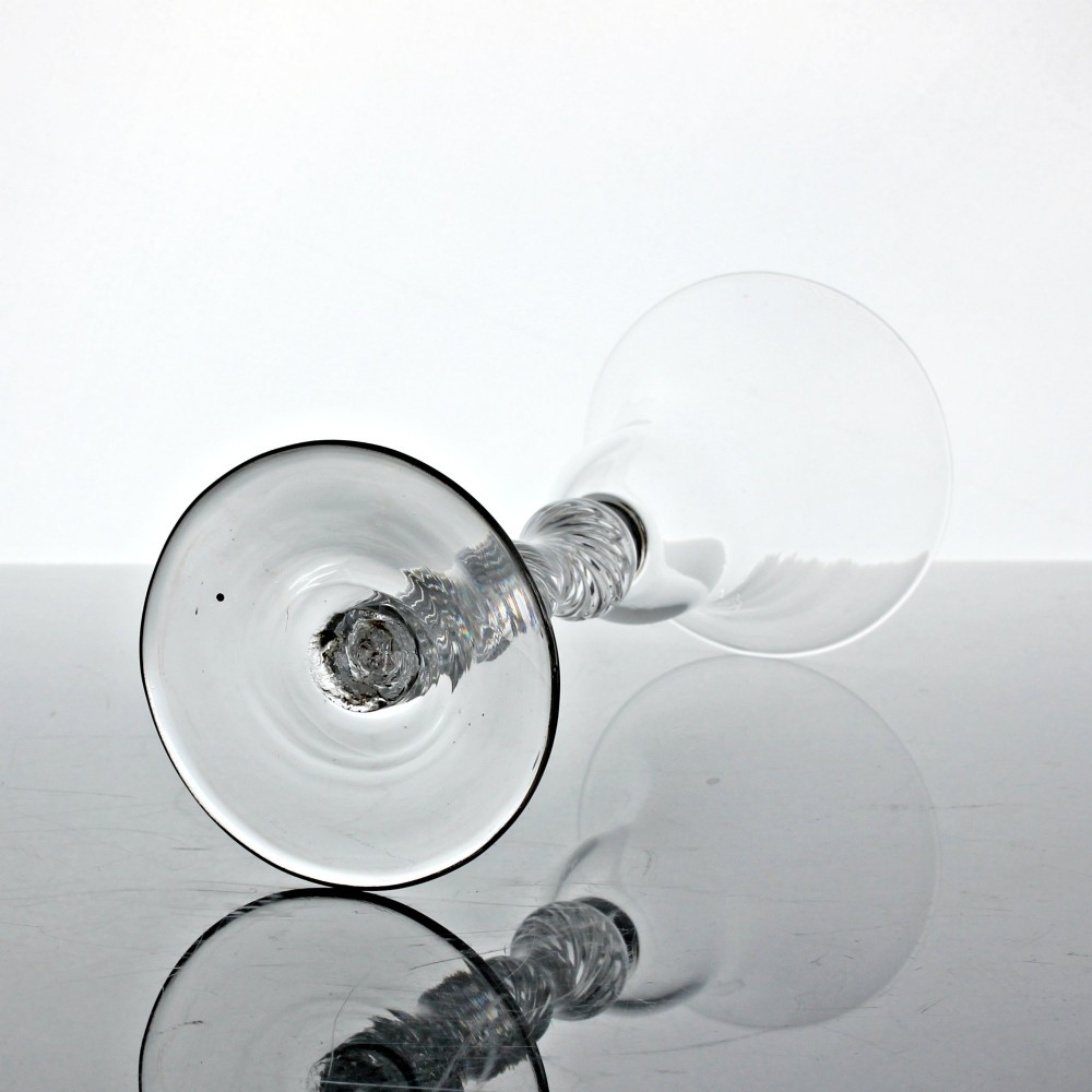 A Georgian clear glass wine goblet featuring a flared bell bowl resting on a multi-spiral air twist stem with four knops over a conical foot. View III