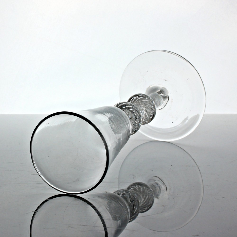 A tall clear glass featuring a conical bowl, a multi-spiral air twist stem with knops, and a circular flat foot. View II
