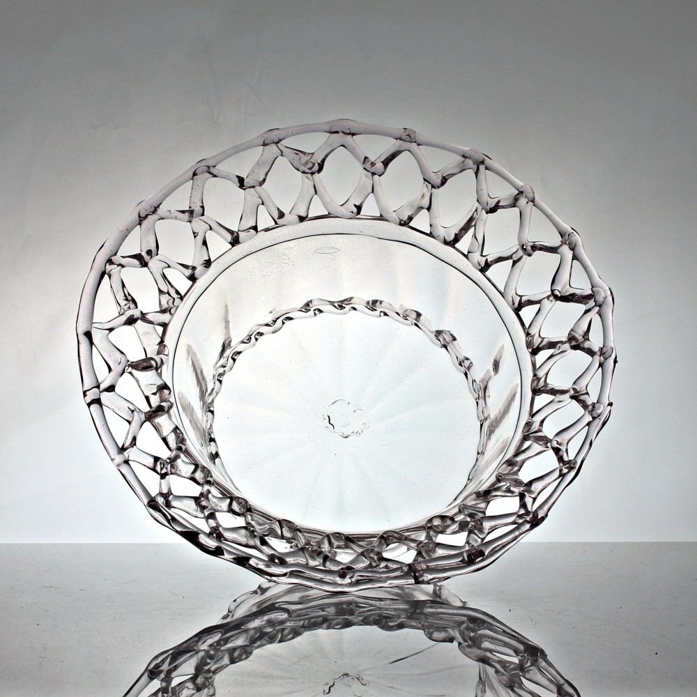 A clear hand-blown glass bowl featuring a fluted lower body and an openwork reticulated lattice rim. View II