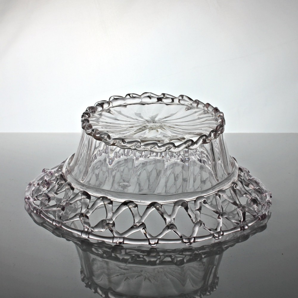 A clear hand-blown glass bowl featuring a fluted lower body and an openwork reticulated lattice rim. View III