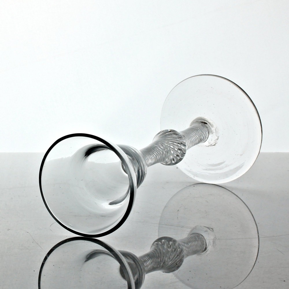 A Georgian clear lead glass wine glass featuring a pan top bowl resting on a multi-spiral air twist stem with a central knop and a wide conical foot. View II