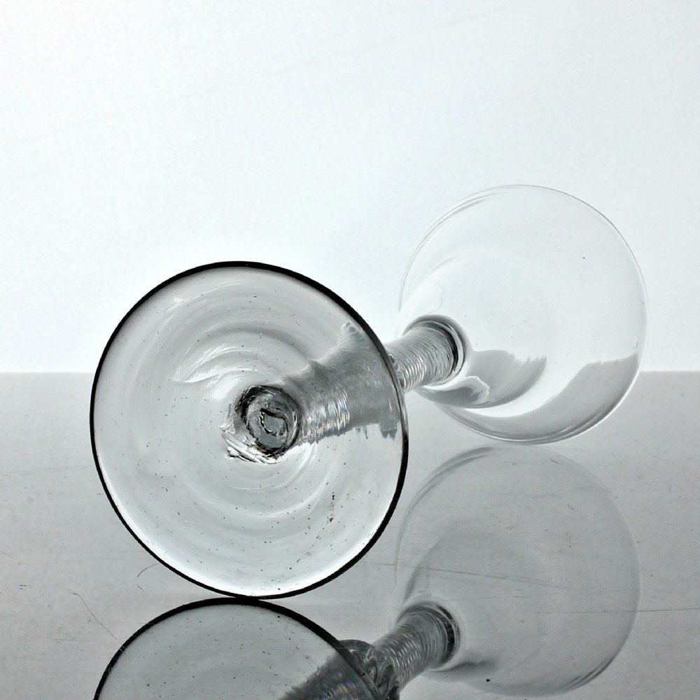 A Georgian clear lead glass wine glass featuring a pan top bowl resting on a multi-spiral air twist stem with a central knop and a wide conical foot. View III