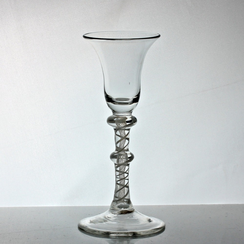 A Georgian clear glass wine glass featuring a bell bowl, a double-knapped stem with internal white opaque twist spirals, and a conical foot. View II