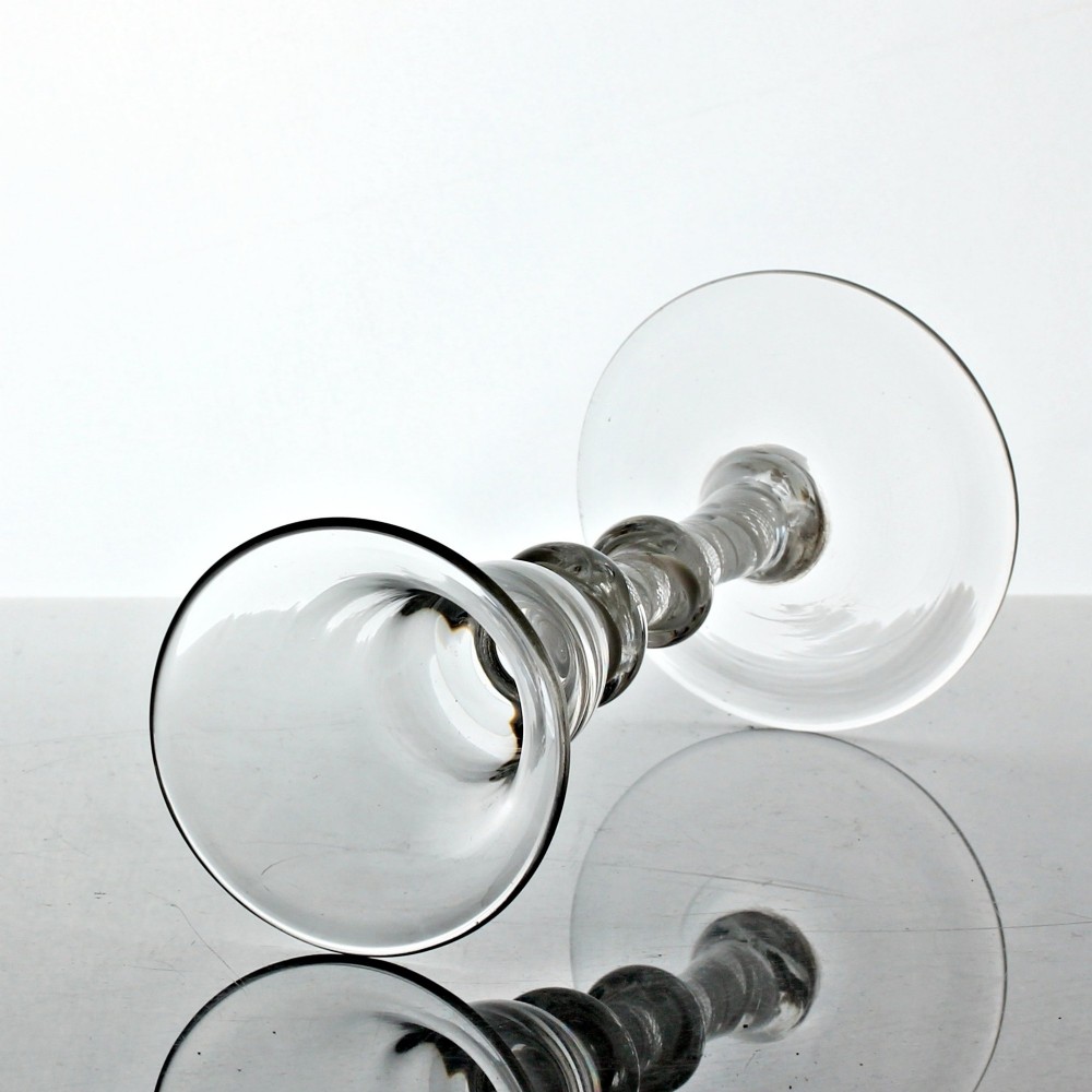 A Georgian clear glass wine glass featuring a bell bowl, a double-knapped stem with internal white opaque twist spirals, and a conical foot. View III