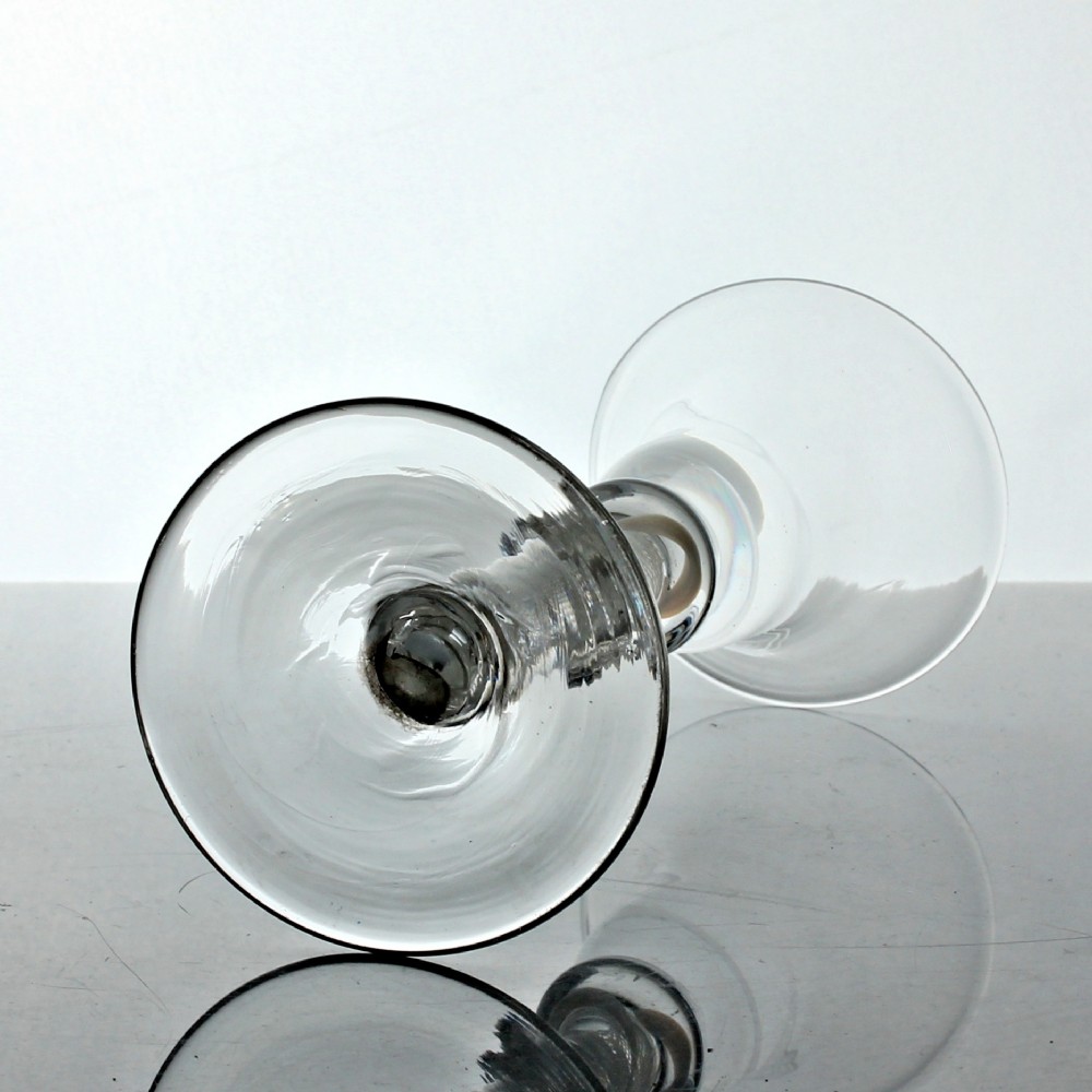 A Georgian clear glass wine glass featuring a bell bowl, a double-knapped stem with internal white opaque twist spirals, and a conical foot. View IV