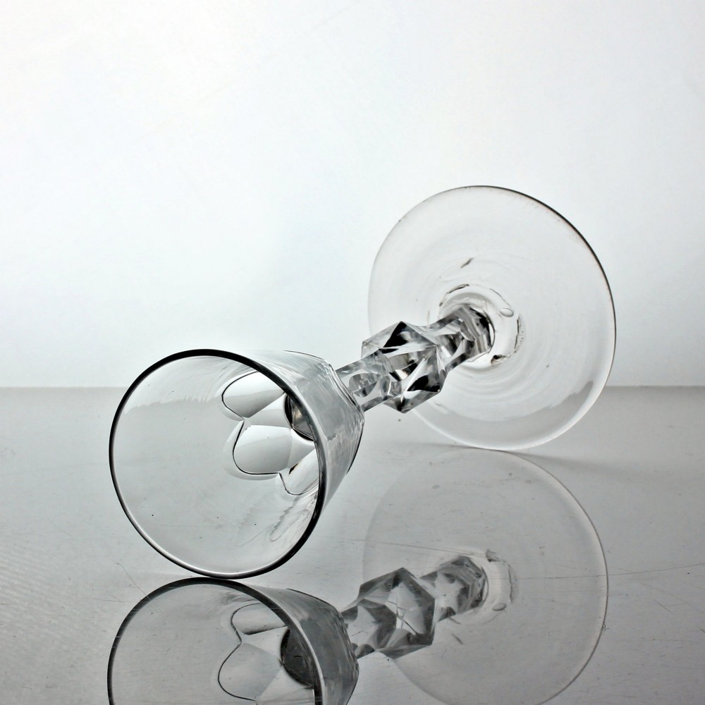 A Georgian clear glass wine goblet featuring a conical bowl, a facet-cut knopped stem, and a circular flat foot. View II