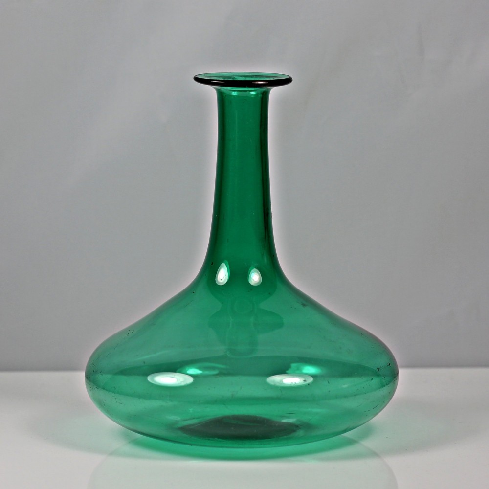 An emerald green hand-blown glass mell decanter featuring a wide flattened base and a long slender neck with a flat lip.