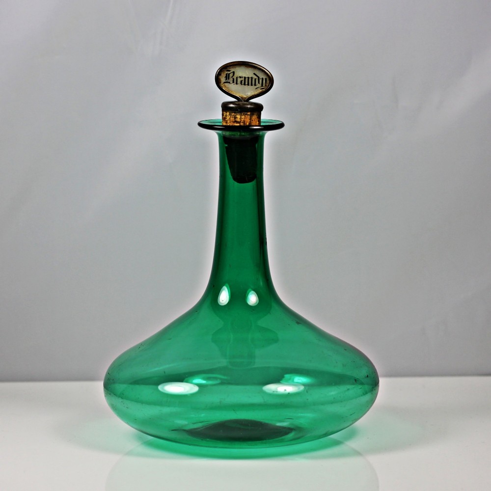 An emerald green hand-blown glass mell decanter featuring a wide flattened base and a long slender neck with a flat lip. View II