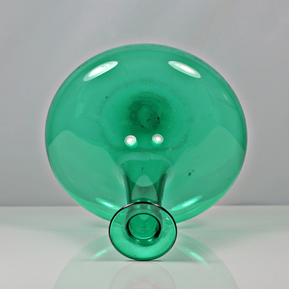 An emerald green hand-blown glass mell decanter featuring a wide flattened base and a long slender neck with a flat lip. View III