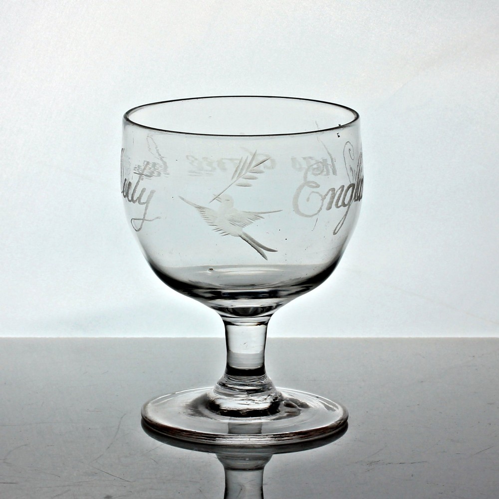 A clear Georgian glass rummer with wheel-engraved script reading England has done her duty set on a short stem and circular foot. View IV
