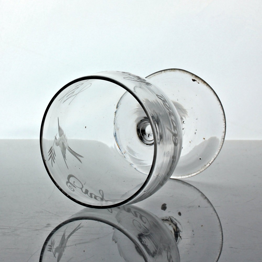 A clear Georgian glass rummer with wheel-engraved script reading England has done her duty set on a short stem and circular foot. View V