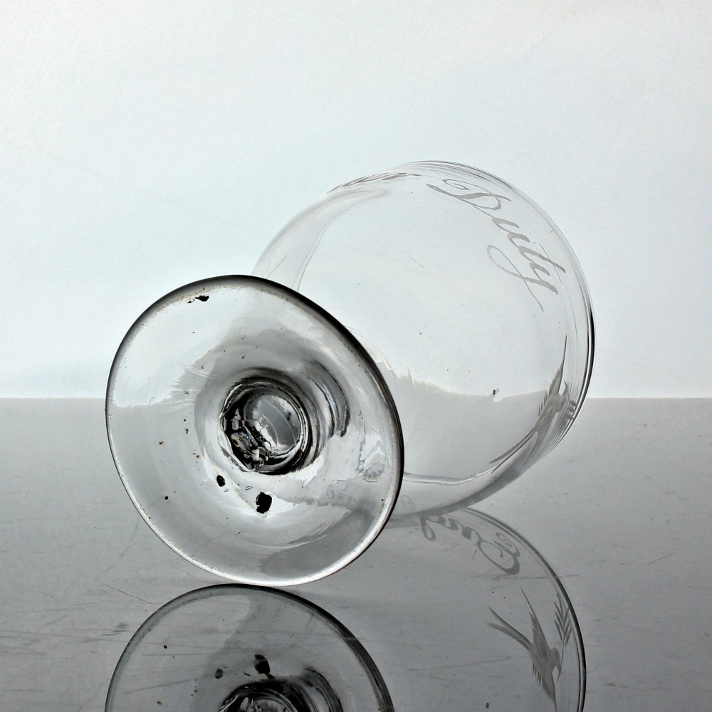 A clear Georgian glass rummer with wheel-engraved script reading England has done her duty set on a short stem and circular foot. View VI