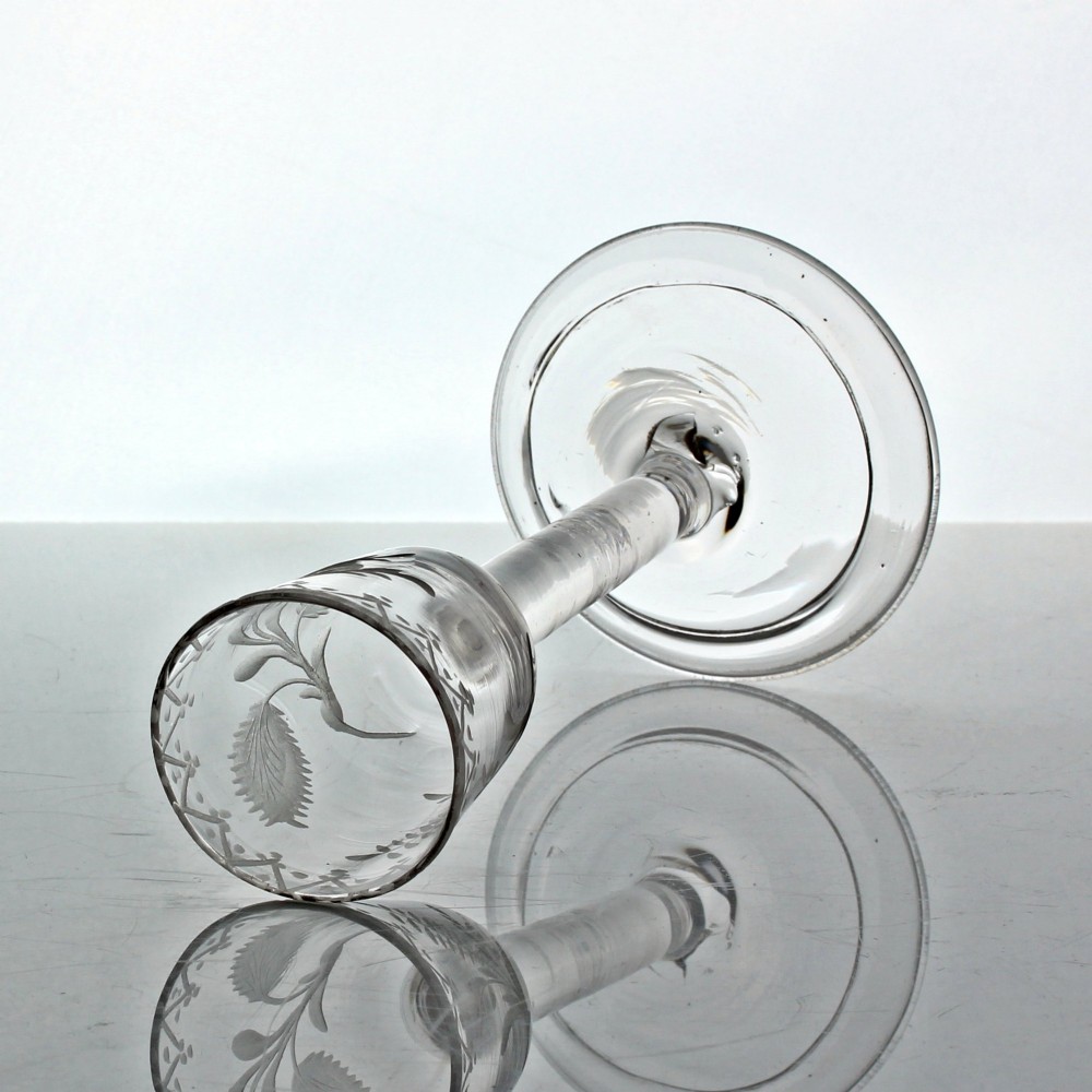 An 18th-century Georgian clear lead glass wine glass featuring a plain stem, circular base, and wheel-engraved floral motif on the bowl. View IV
