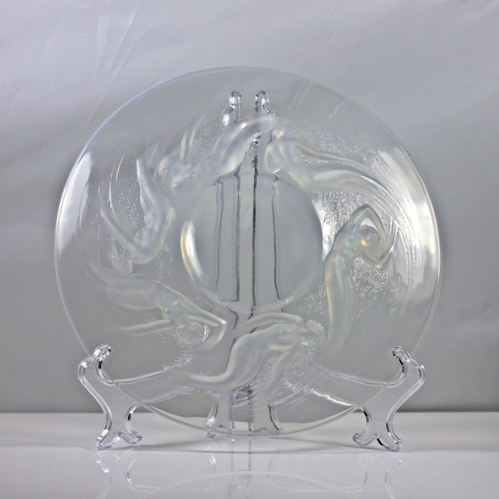 A circular Rene Lalique opalescent glass dish featuring a relief pattern of six swirling female nudes surrounding a smooth central recess. View III