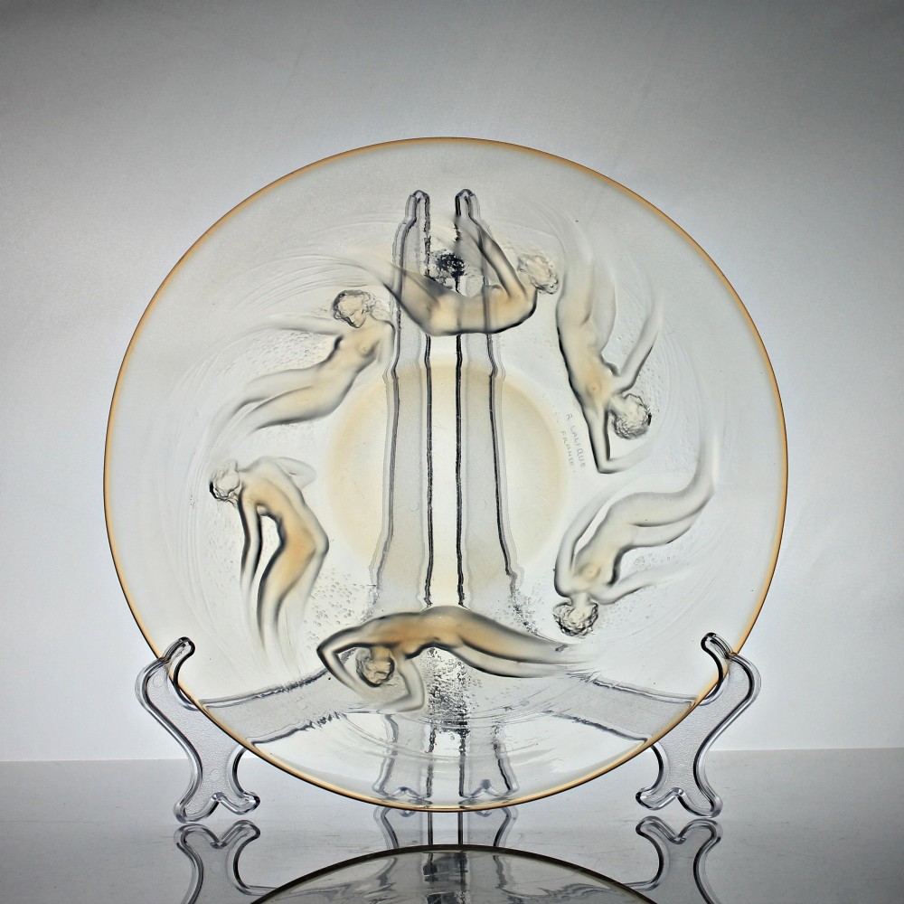A circular Rene Lalique opalescent glass dish featuring a relief pattern of six swirling female nudes surrounding a smooth central recess. View IV