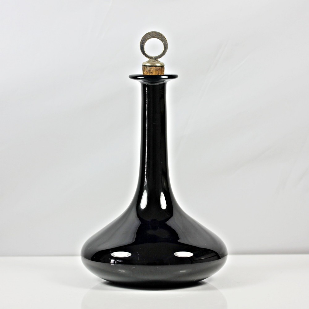 A pair of deep cobalt Bristol blue glass mell-shaped decanters featuring slender necks and metal ring stoppers labelled Claret and Brandy. View II