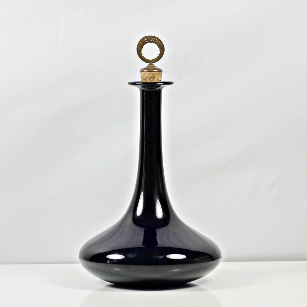 A pair of deep cobalt Bristol blue glass mell-shaped decanters featuring slender necks and metal ring stoppers labelled Claret and Brandy. View V