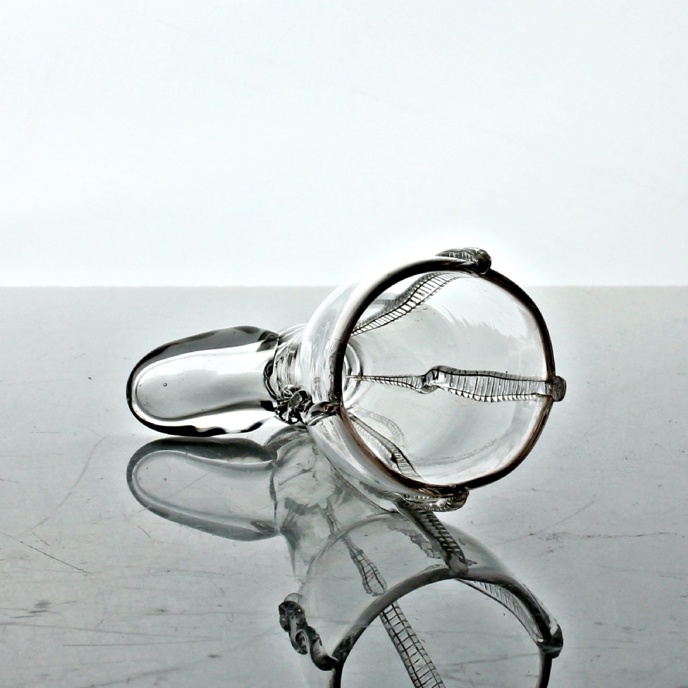 A clear hand-blown Georgian glass vessel modelled in the shape of a boot with vertical rigaree decoration. View III