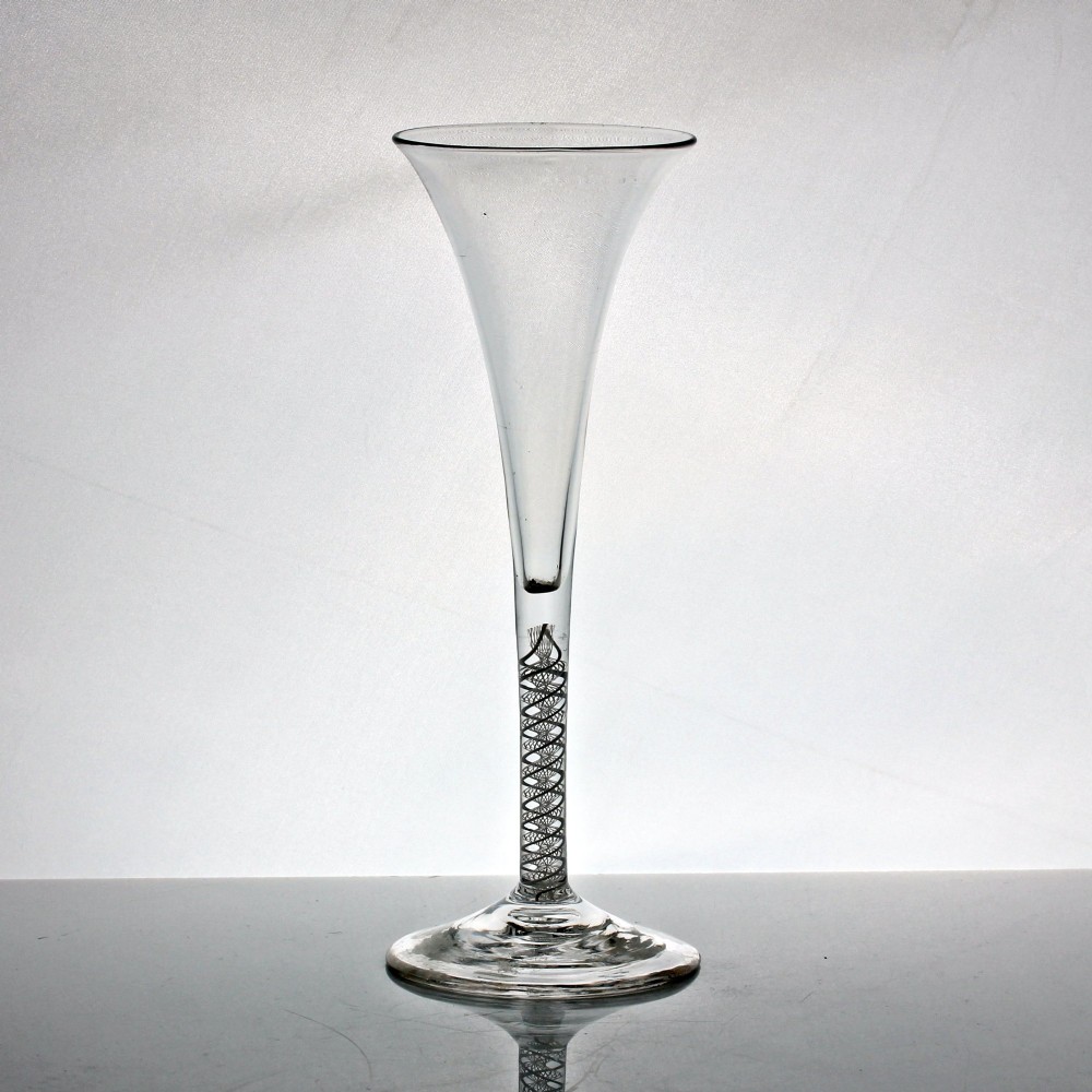 An 18th-century clear glass wine glass featuring a tall trumpet-shaped bowl, a double series opaque twist stem, and a wide conical foot. View II