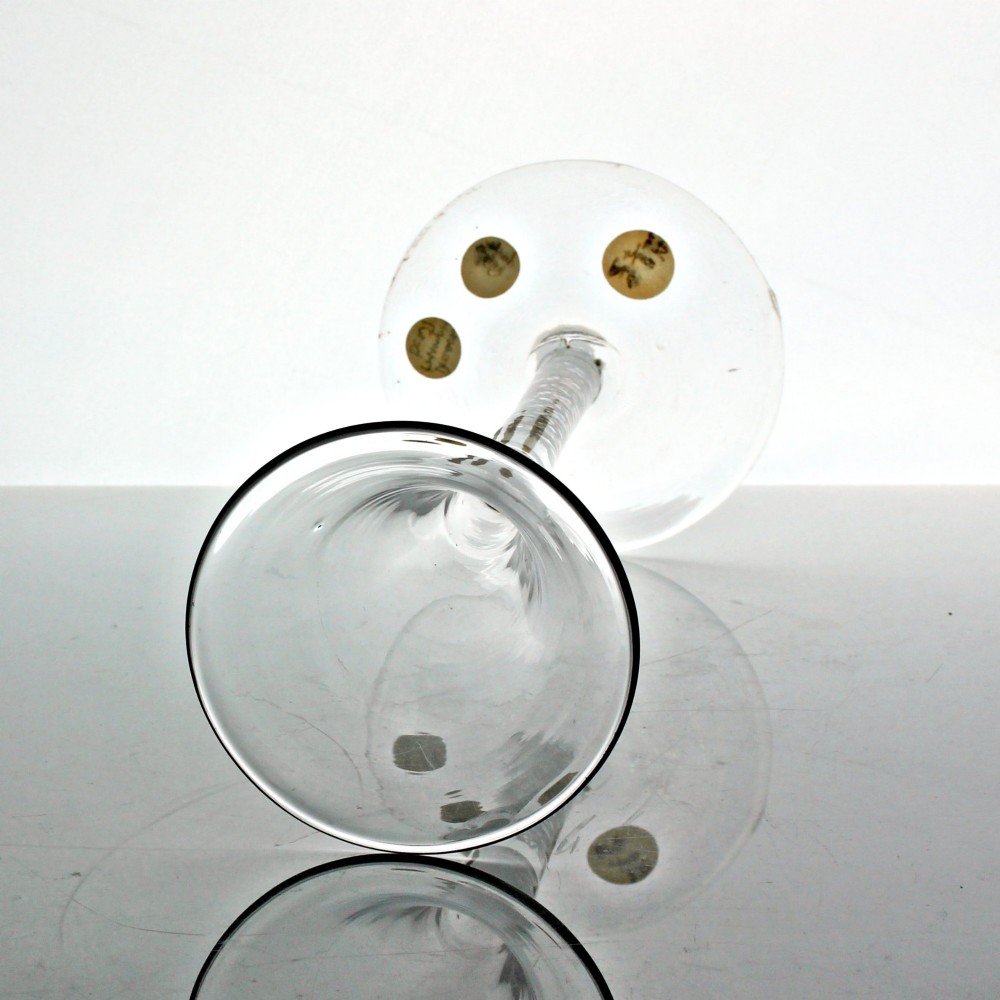 An 18th-century clear glass wine glass featuring a tall trumpet-shaped bowl, a double series opaque twist stem, and a wide conical foot. View III