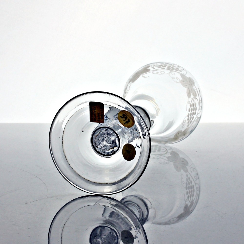 A clear Georgian lead glass wine goblet featuring an engraved vine motif around a pan-topped bowl and a multi-knopped stem. View III