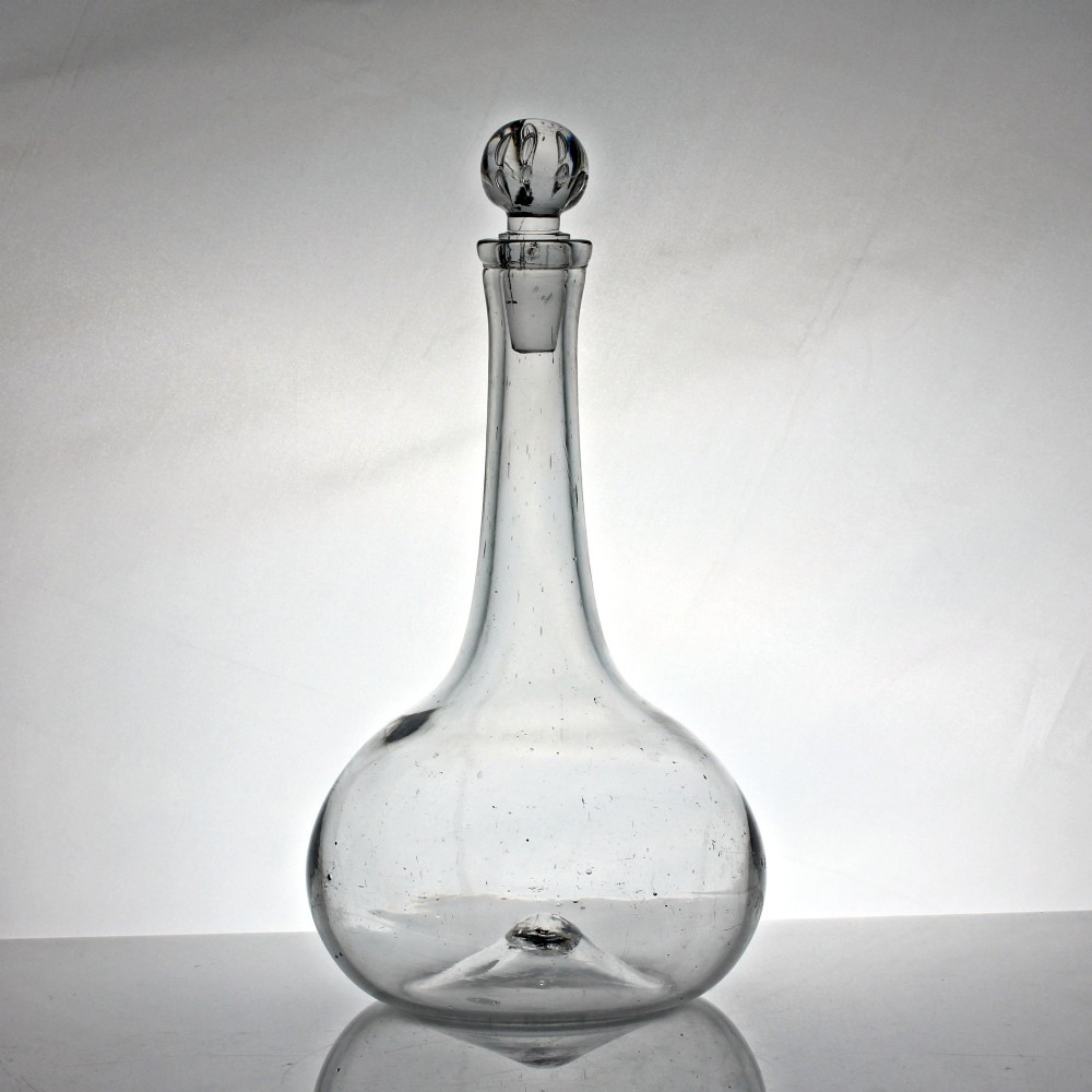 An 18th-century Georgian clear hand-blown glass shaft and globe decanter featuring a spherical base, long slender neck, and matching glass ball stopper.