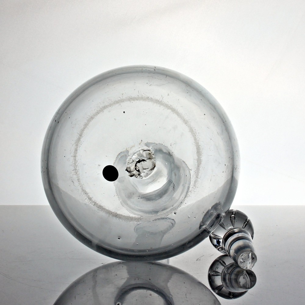 An 18th-century Georgian clear hand-blown glass shaft and globe decanter featuring a spherical base, long slender neck, and matching glass ball stopper. View IV