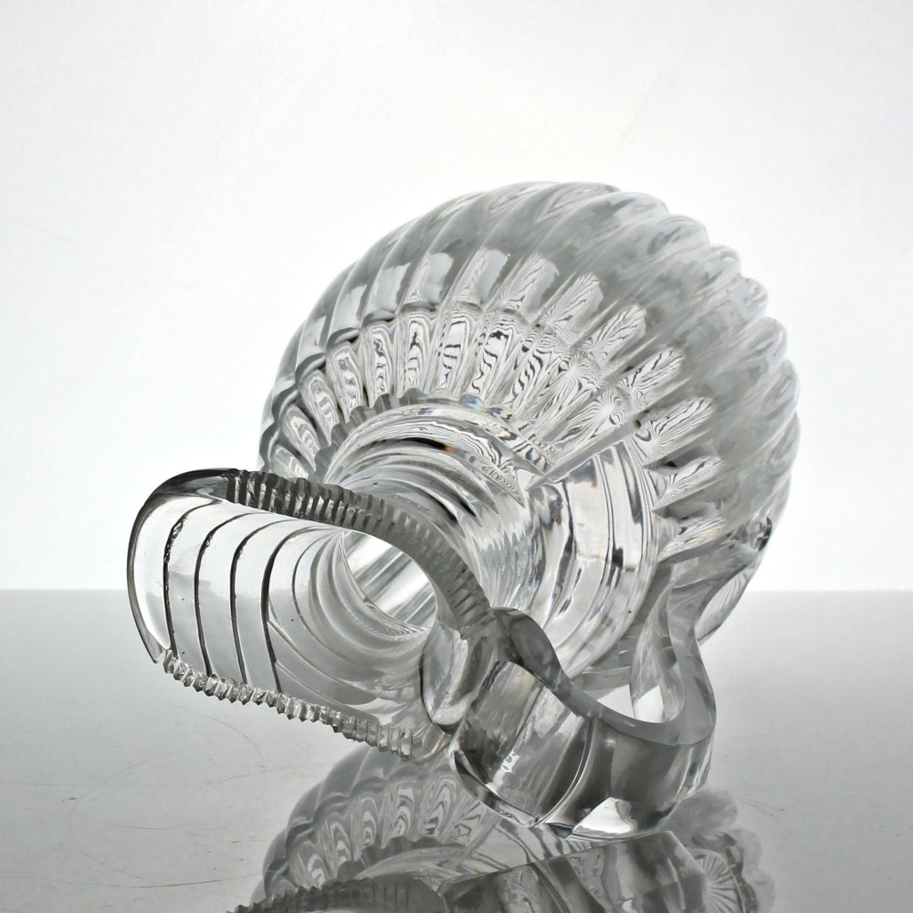 A clear Georgian lead crystal water jug featuring vertical pillar cutting around the lower body, neck rings, and a notched poured spout with an applied handle. View III