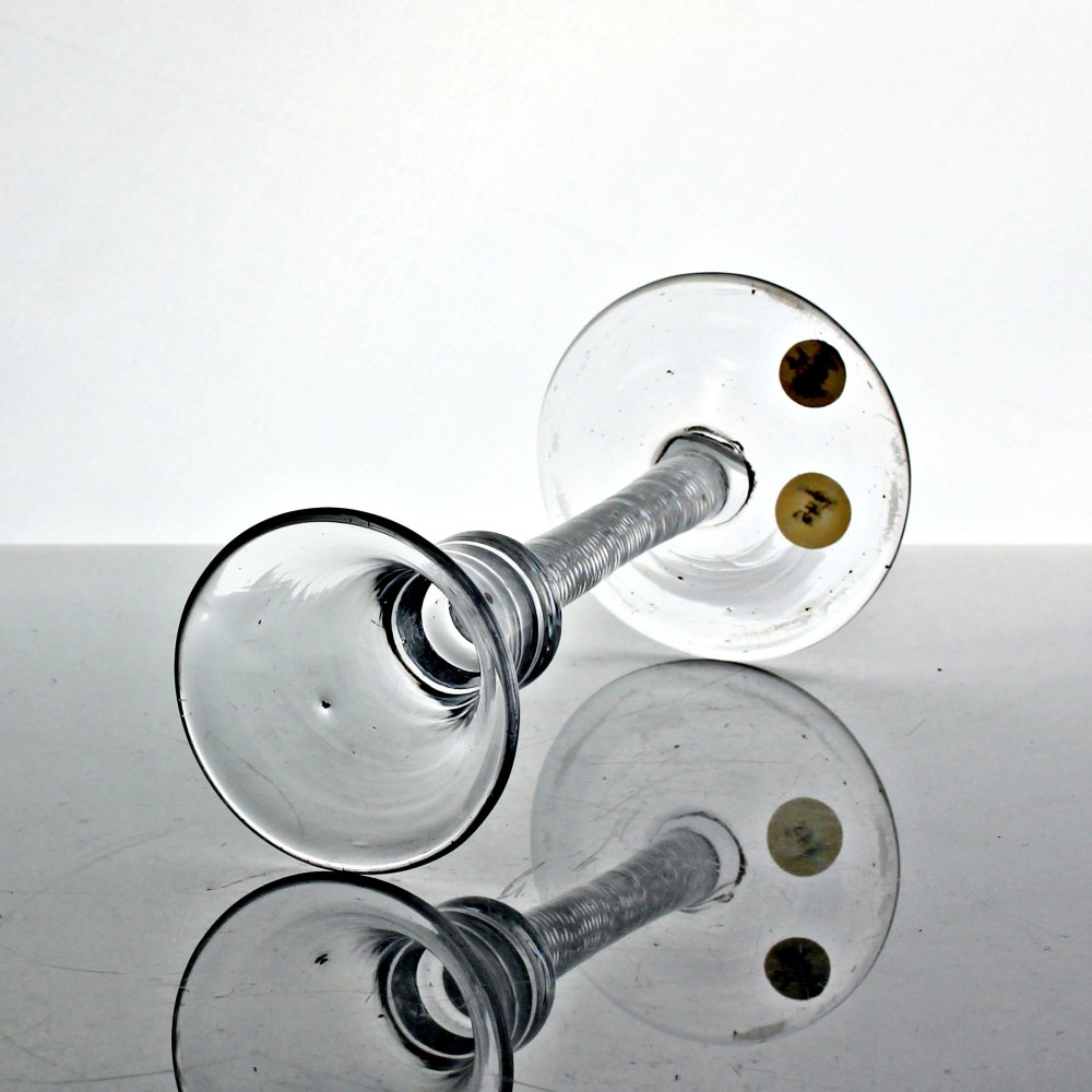 An eighteenth-century clear lead glass wine glass featuring a waisted bucket bowl, a multi-spiral air twist stem, and a flat conical foot. View II