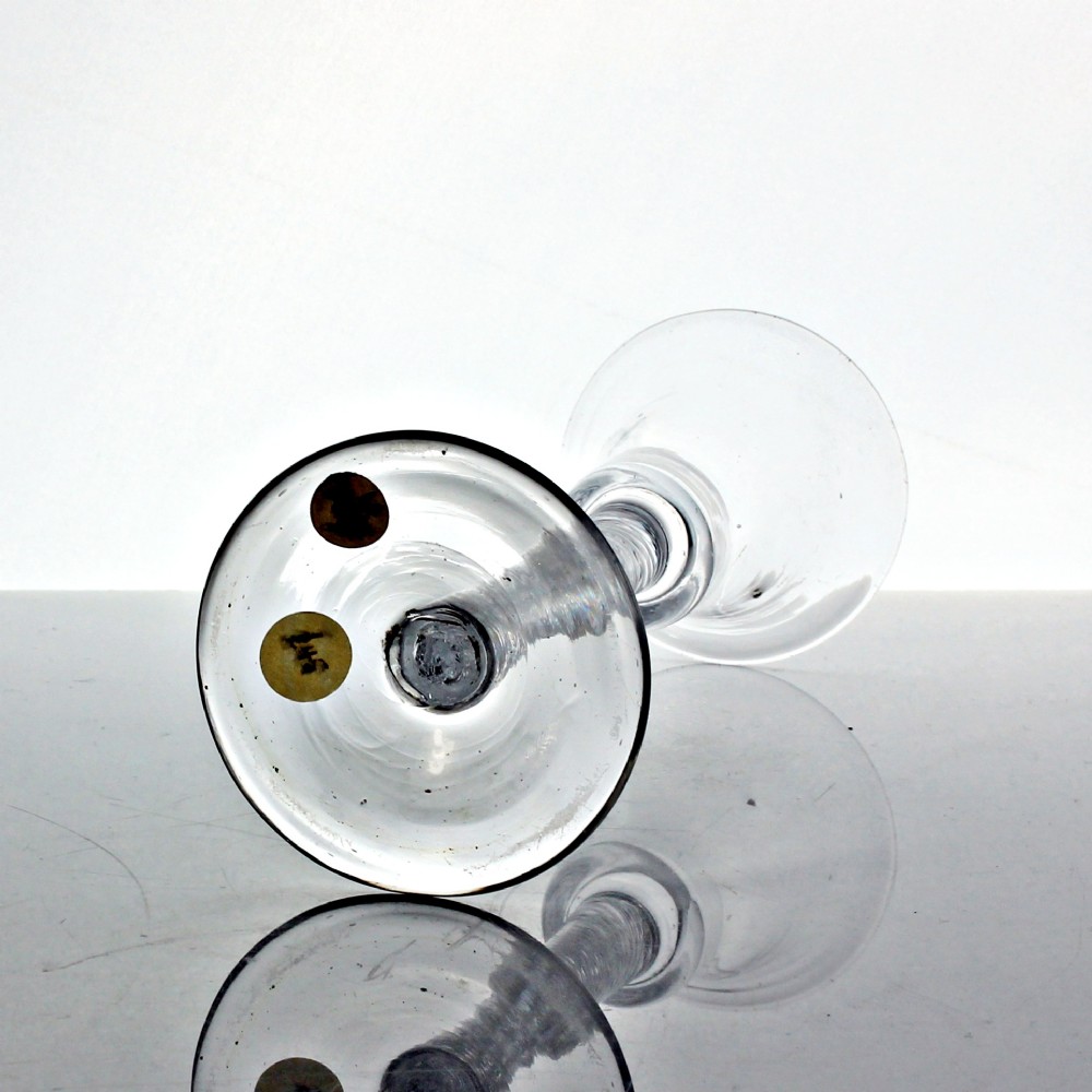 An eighteenth-century clear lead glass wine glass featuring a waisted bucket bowl, a multi-spiral air twist stem, and a flat conical foot. View III